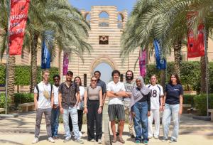  a group of international students taking a group photo at AUC Portal