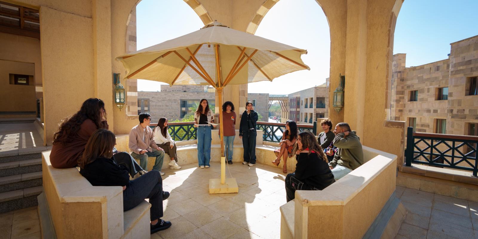 students meeting with their professor outside the classroom