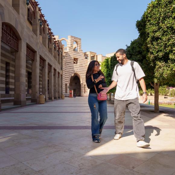 a girl and a boy walking together on campus
