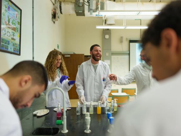 students in a lab room doing an experiment