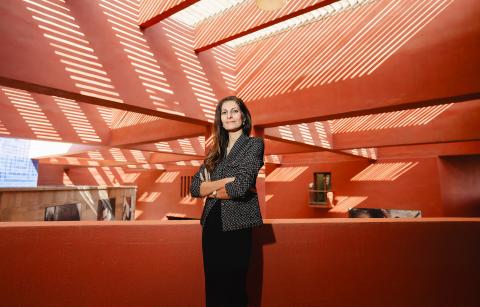 A woman is standing on a covered roof