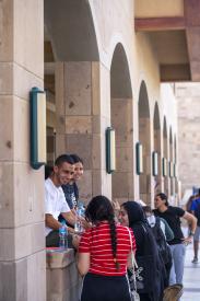 A group of girls and boys on campus talking
