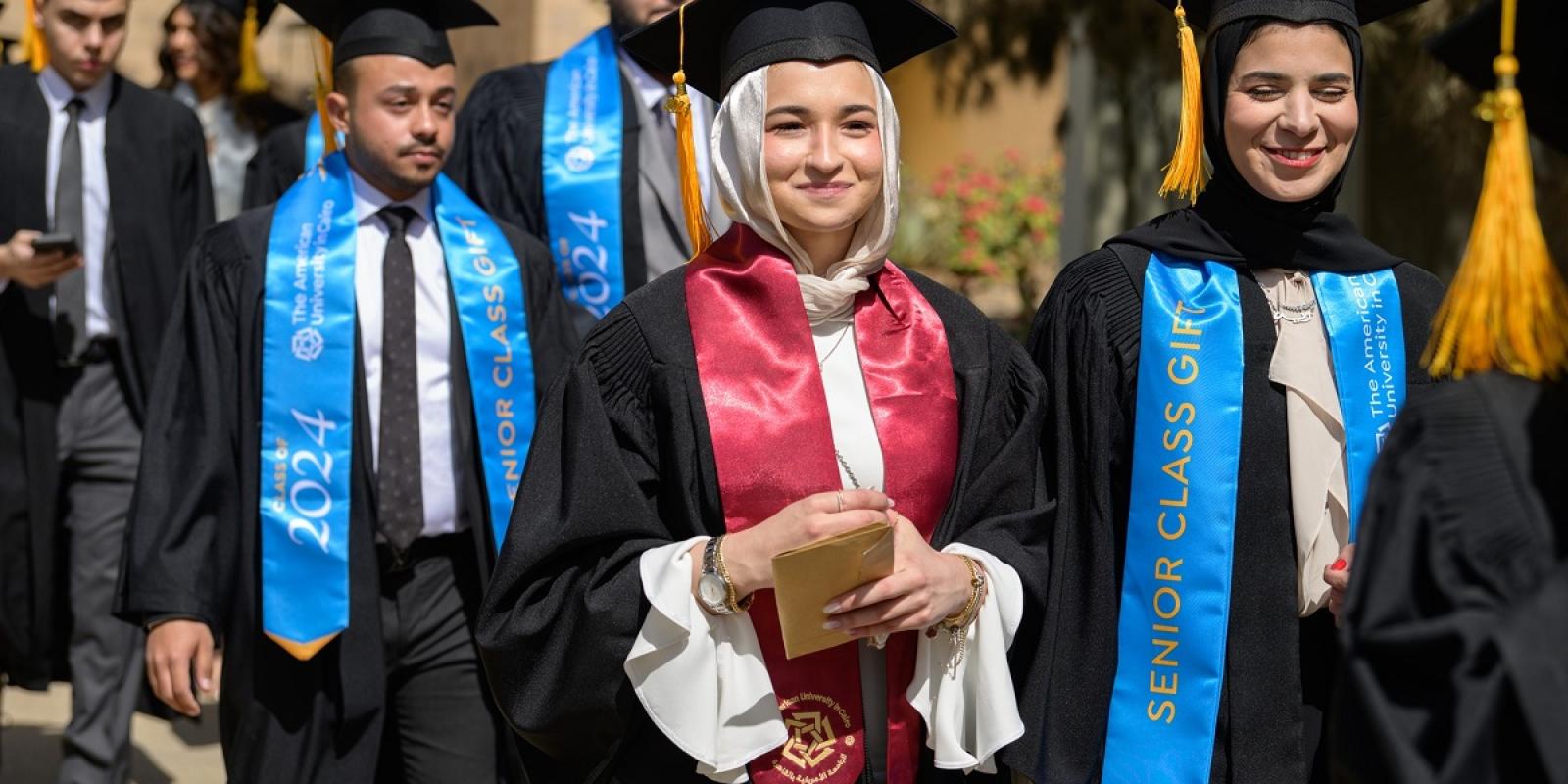Students wearing their graduation caps and gowns