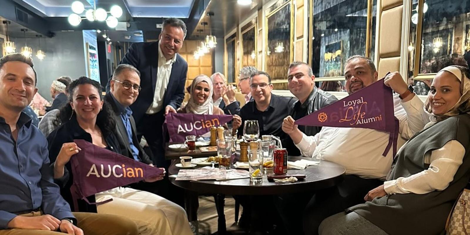 Men and women sitting together at a table in a restaurant