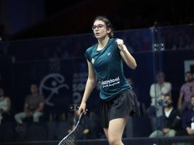 a woman playing squash