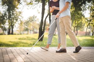 visual impaired person guided by someone