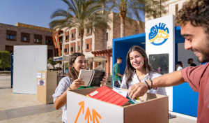Students pick up books from a box